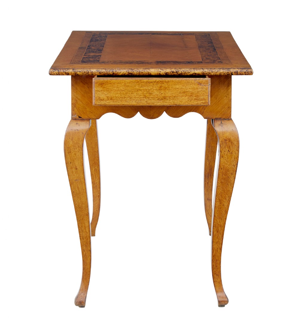 A mid 19th-century Swedish rectangular occasional table crafted from golden brown alder root wood with slender cabriole legs and a contoured apron. View III
