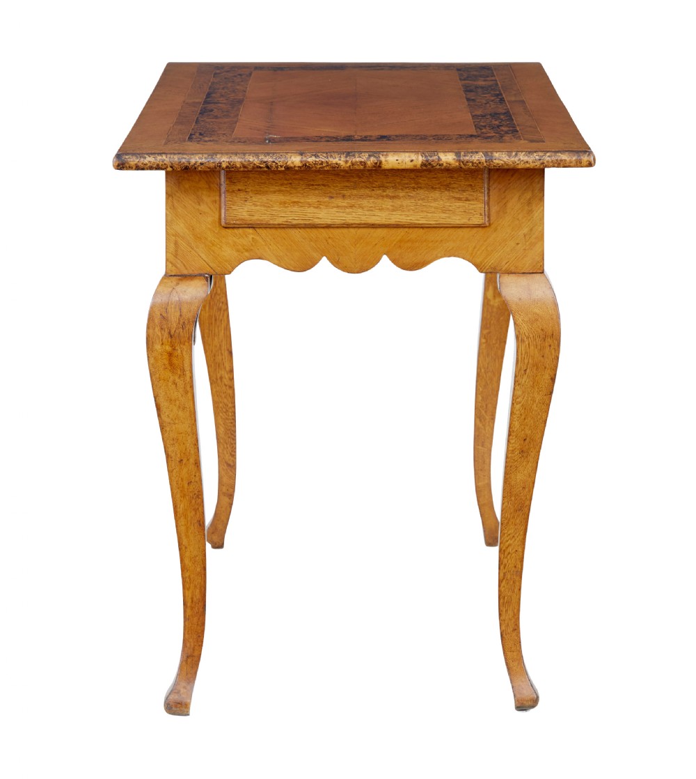 A mid 19th-century Swedish rectangular occasional table crafted from golden brown alder root wood with slender cabriole legs and a contoured apron. View V