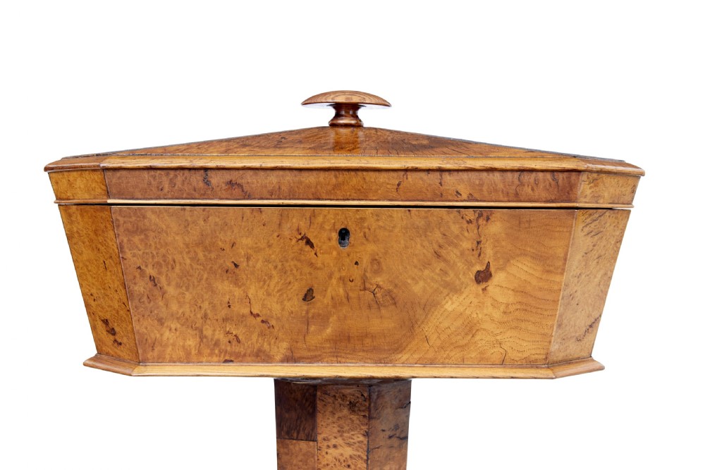A nineteenth-century Swedish burr elm teapoy featuring an octagonal casket lid, a faceted pedestal column, and a shaped plinth base. View III