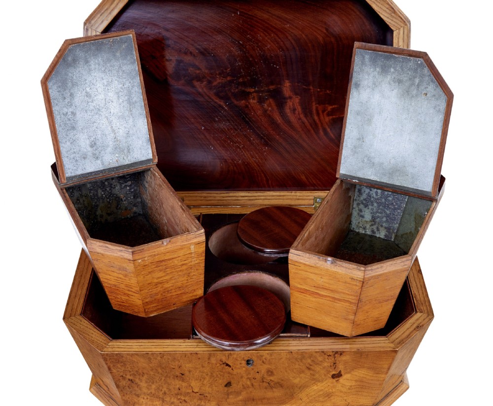 A nineteenth-century Swedish burr elm teapoy featuring an octagonal casket lid, a faceted pedestal column, and a shaped plinth base. View IV