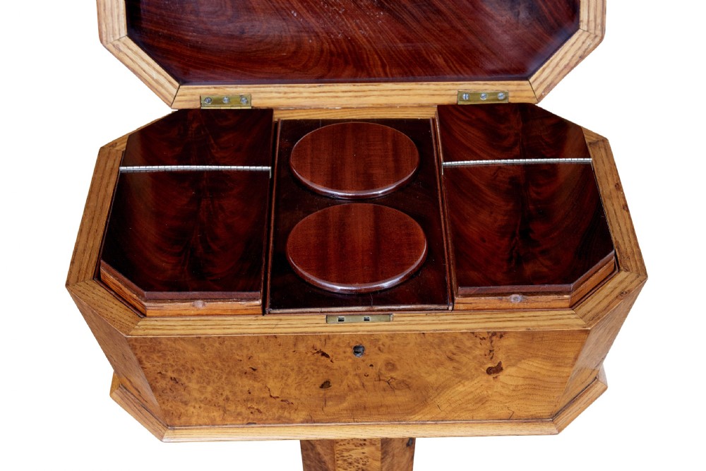 A nineteenth-century Swedish burr elm teapoy featuring an octagonal casket lid, a faceted pedestal column, and a shaped plinth base. View V