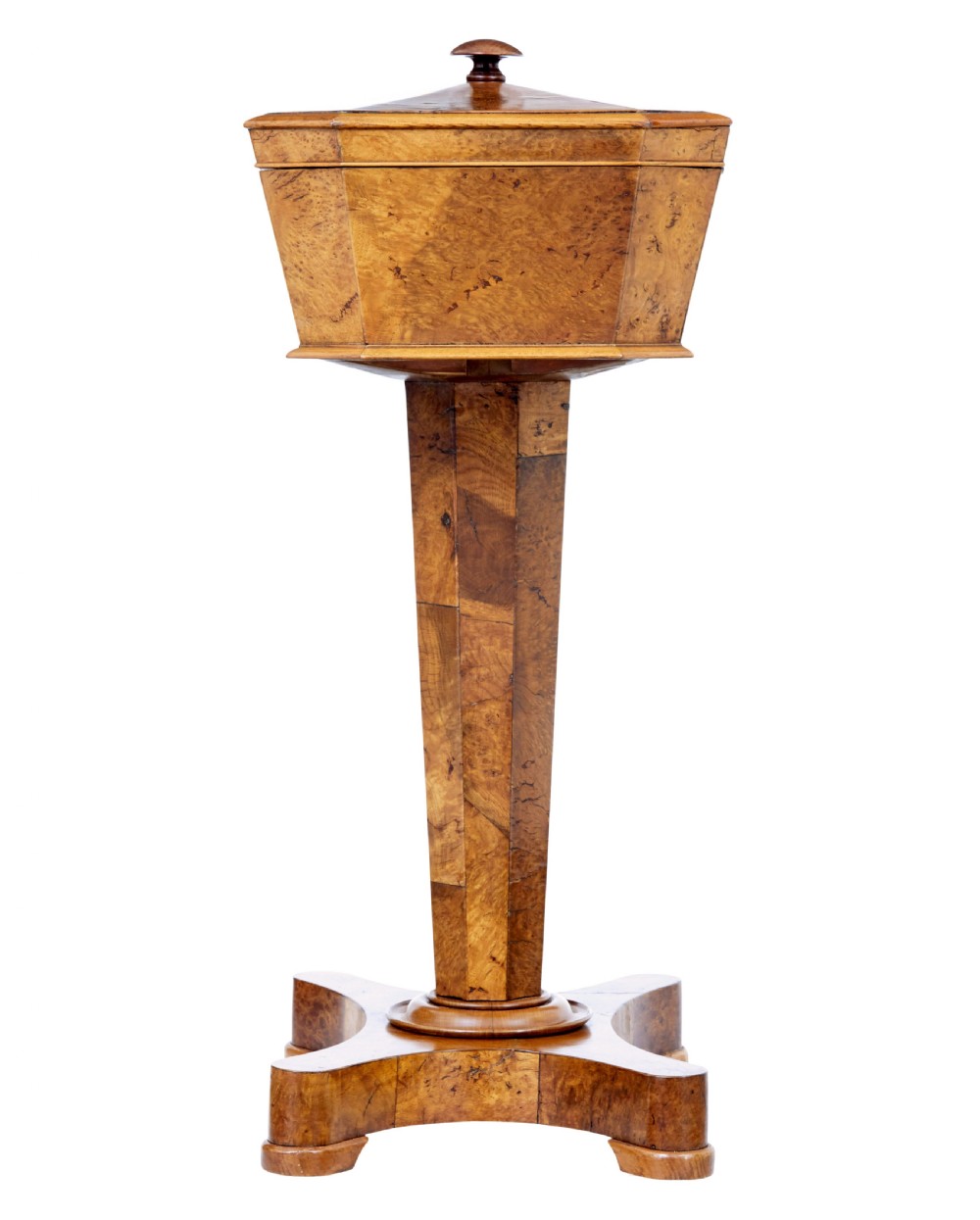 A nineteenth-century Swedish burr elm teapoy featuring an octagonal casket lid, a faceted pedestal column, and a shaped plinth base. View VII