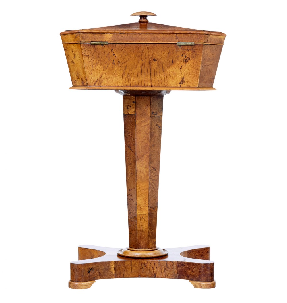 A nineteenth-century Swedish burr elm teapoy featuring an octagonal casket lid, a faceted pedestal column, and a shaped plinth base. View VIII