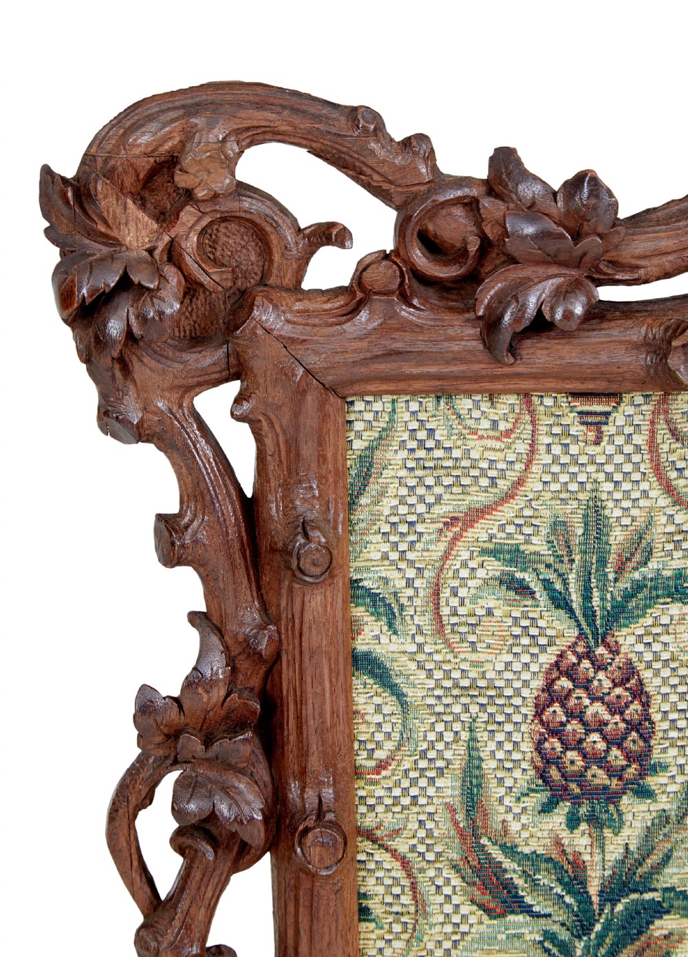 A carved oak tripod fire screen with a crest carved as a bird surrounding a woven tapestry panel featuring pineapple motifs. View III