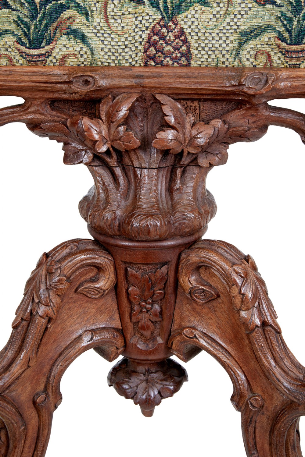 A carved oak tripod fire screen with a crest carved as a bird surrounding a woven tapestry panel featuring pineapple motifs. View IV
