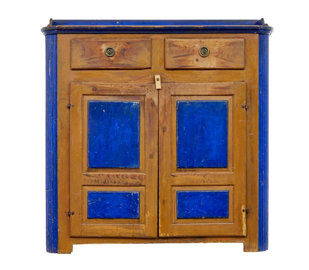 A 19th-century Swedish pine kitchen cupboard with ochre faux-grained body, vibrant blue fluted columns, two top drawers, and blue panelled double doors. View II