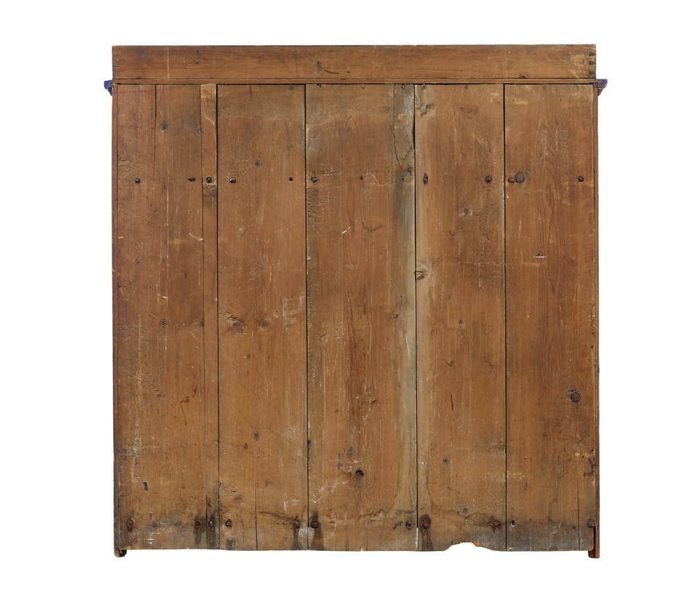 A 19th-century Swedish pine kitchen cupboard with ochre faux-grained body, vibrant blue fluted columns, two top drawers, and blue panelled double doors. View VI