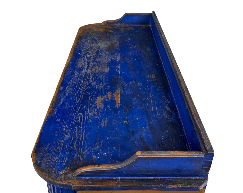 A 19th-century Swedish pine kitchen cupboard with ochre faux-grained body, vibrant blue fluted columns, two top drawers, and blue panelled double doors. View X