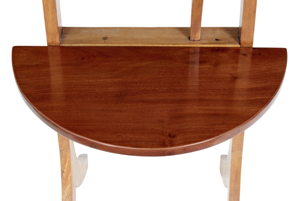 An early 20th-century metamorphic mahogany occasional table featuring an oval top shelf above a lower demi-lune shelf supported by a wooden folding frame. View III