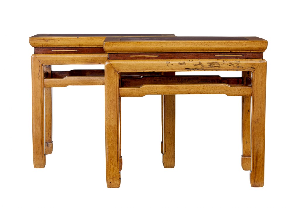 A pair of late nineteenth-century Chinese hardwood occasional tables featuring rectangular tops with inset panels, straight legs, and subtle waist aprons.