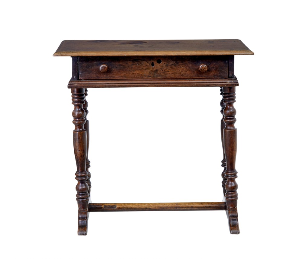 An 18th-century rustic walnut side table featuring turned legs, a single drawer with wooden knobs, and a low stretcher base. View V