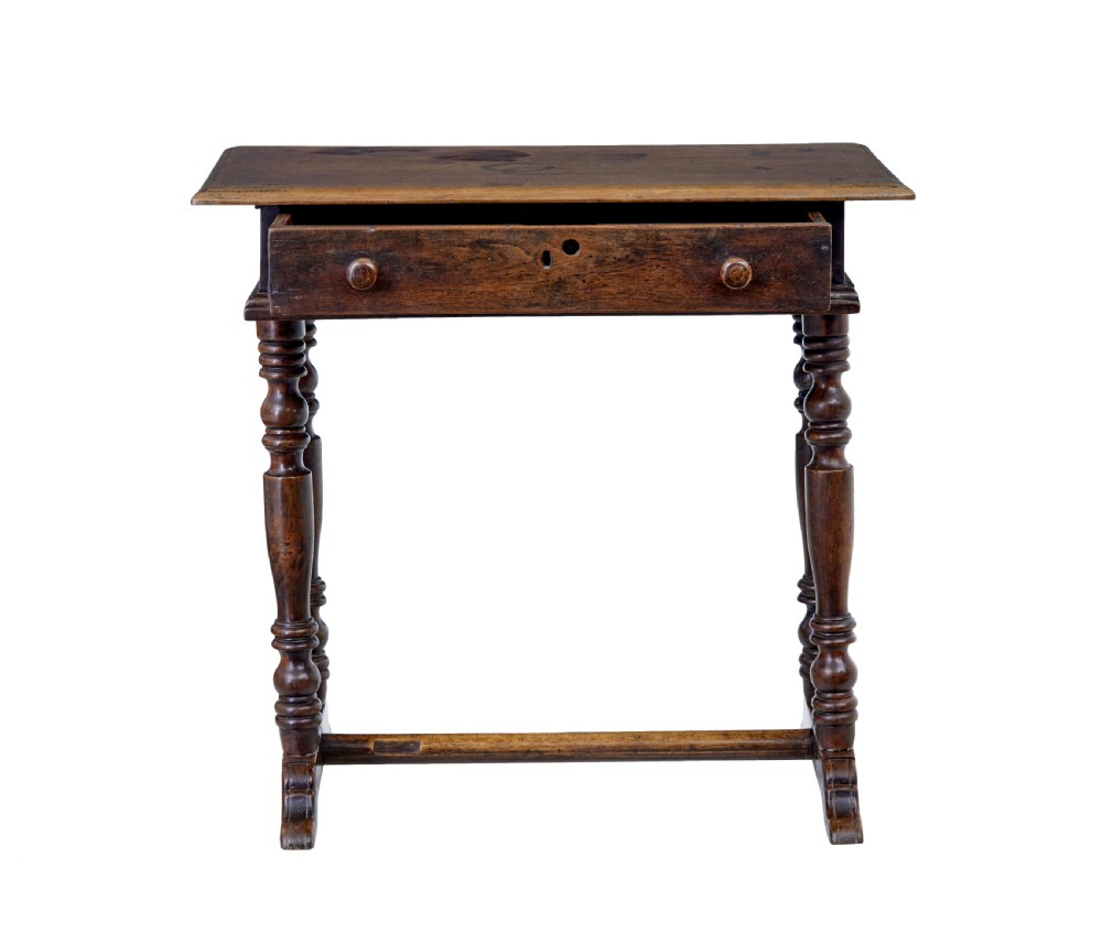 An 18th-century rustic walnut side table featuring turned legs, a single drawer with wooden knobs, and a low stretcher base. View VI