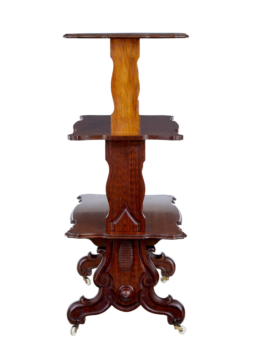 A 19th-century Victorian walnut metamorphic dumb waiter featuring a serpentine moulded top, carved C-scroll side supports, a turned stretcher, and brass castors. View III