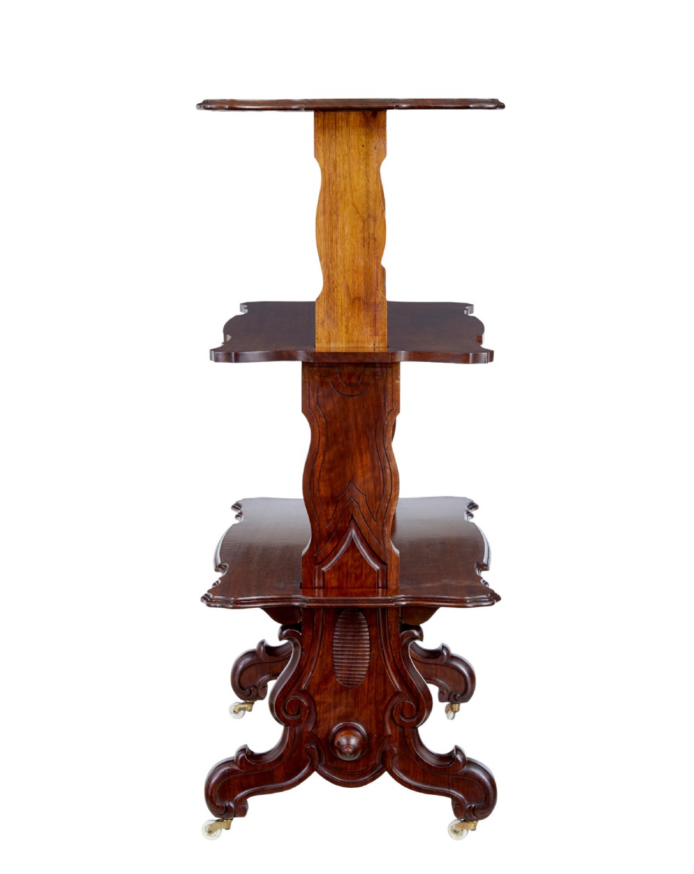A 19th-century Victorian walnut metamorphic dumb waiter featuring a serpentine moulded top, carved C-scroll side supports, a turned stretcher, and brass castors. View IV