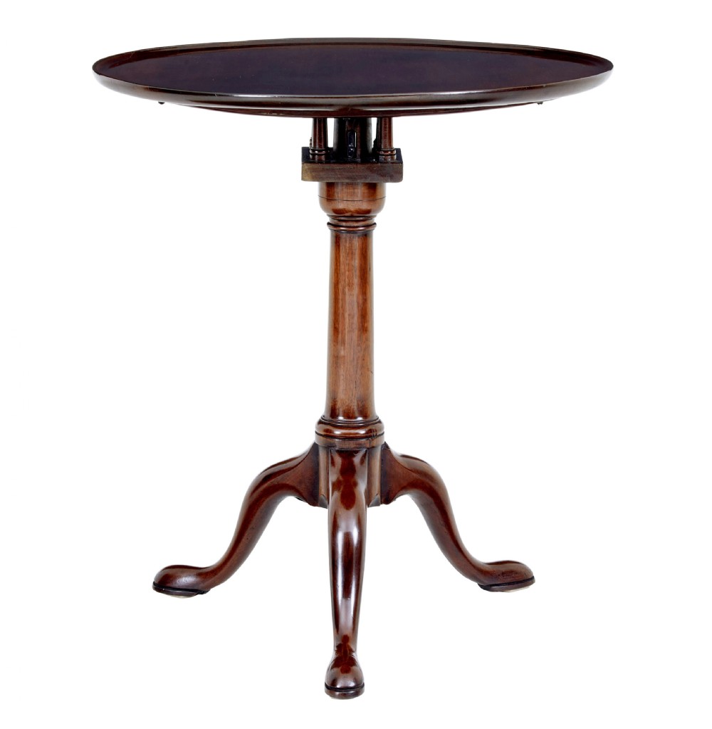 An early 19th-century Georgian mahogany tripod table with a circular tilt top, turned central column, and three cabriole legs on pad feet.