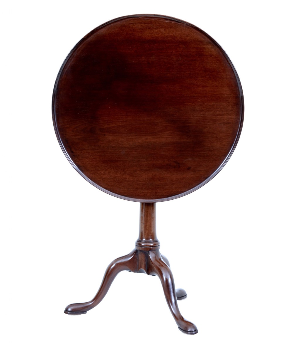 An early 19th-century Georgian mahogany tripod table with a circular tilt top, turned central column, and three cabriole legs on pad feet. View IV