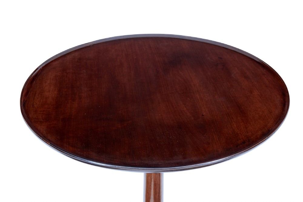 An early 19th-century Georgian mahogany tripod table with a circular tilt top, turned central column, and three cabriole legs on pad feet. View VI