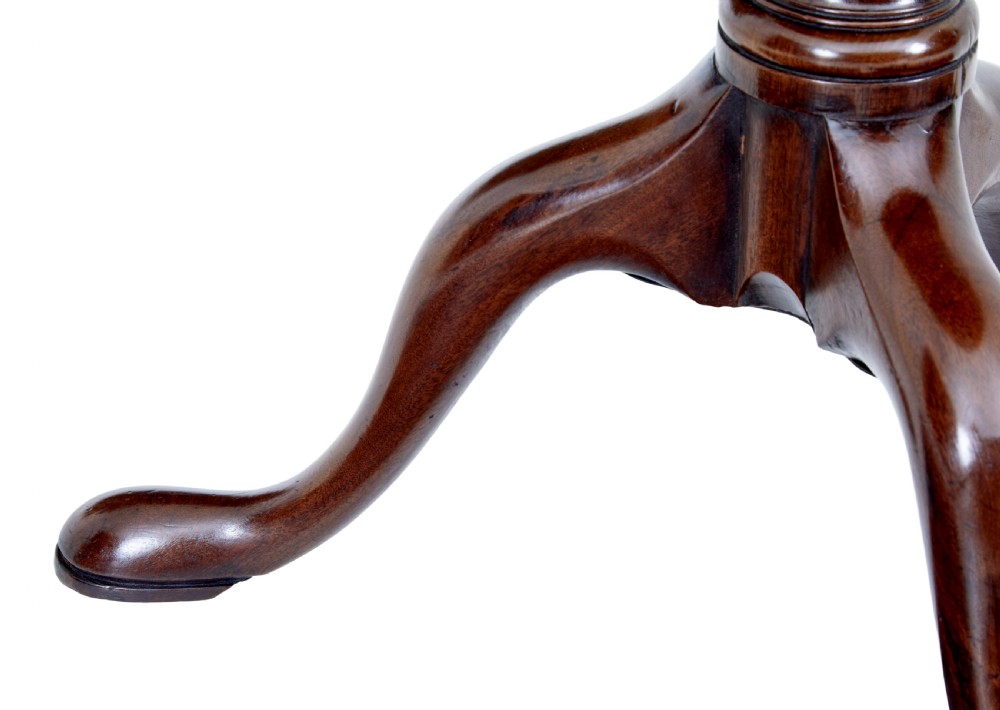 An early 19th-century Georgian mahogany tripod table with a circular tilt top, turned central column, and three cabriole legs on pad feet. View VII