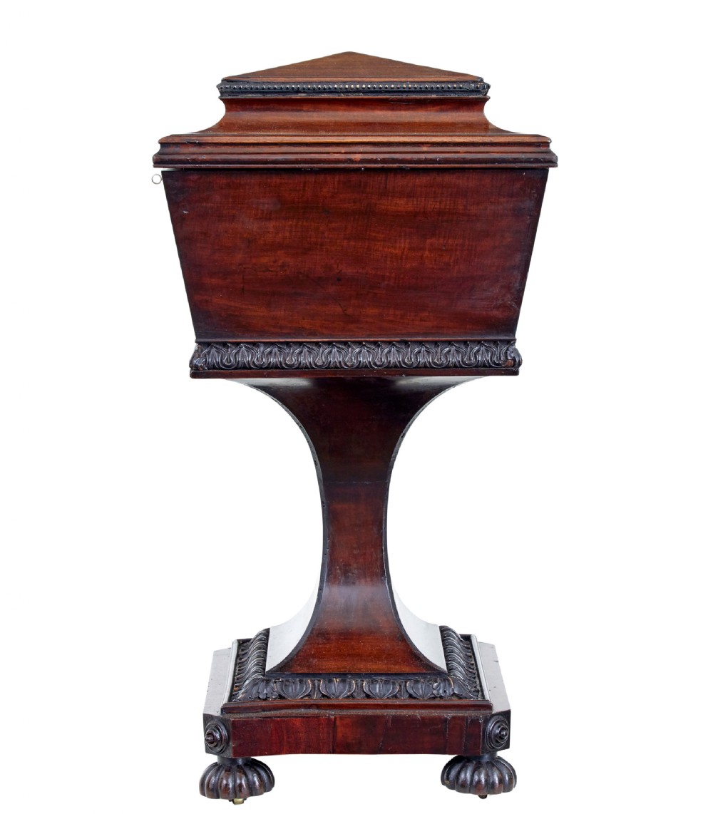 A 19th-century carved mahogany teapoy featuring a stepped hinged lid, flared central pedestal base, and carved feet. View III
