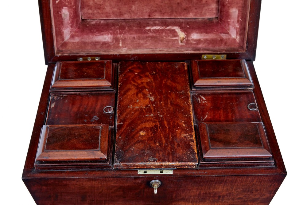 A 19th-century carved mahogany teapoy featuring a stepped hinged lid, flared central pedestal base, and carved feet. View VII