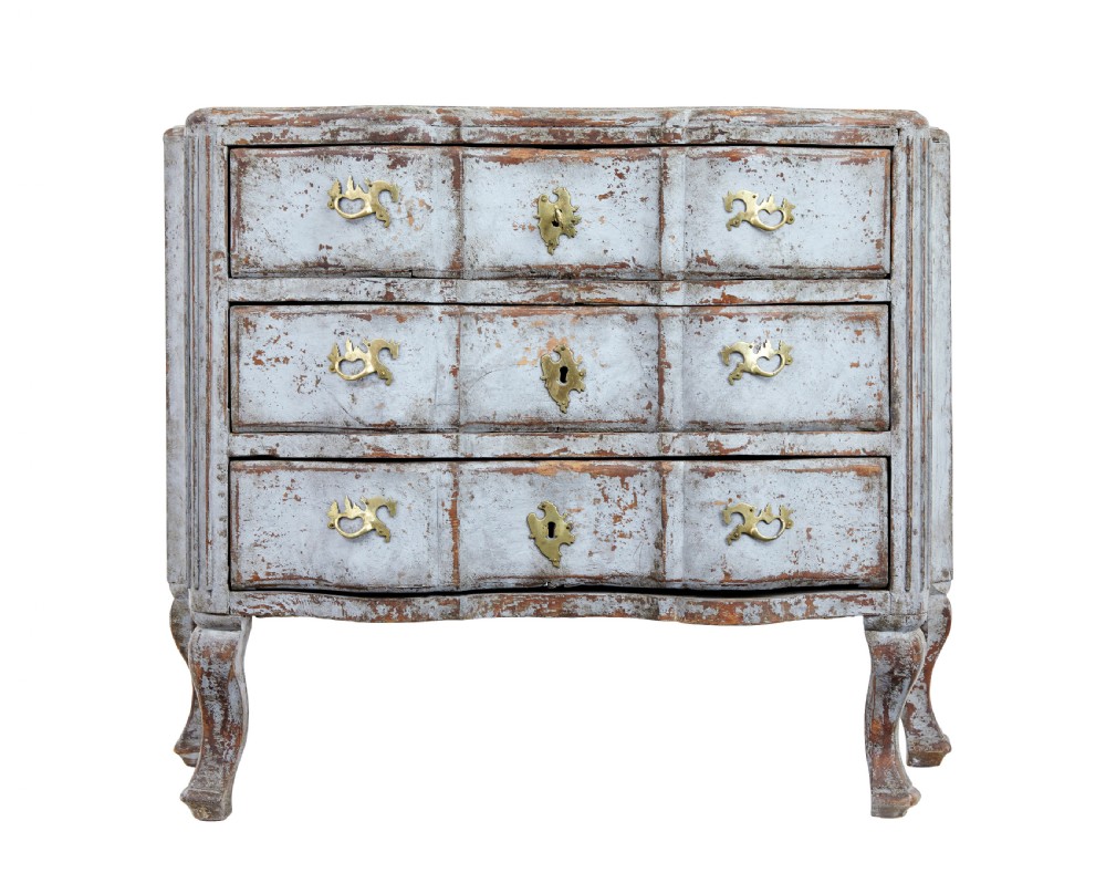 An early nineteenth-century Swedish Baroque Revival chest featuring three drawers with a distressed light blue painted finish and decorative brass handles.