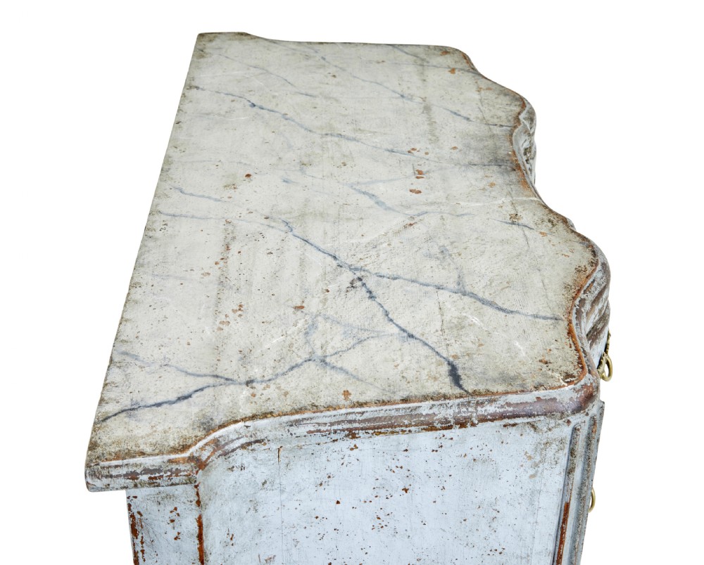 An early nineteenth-century Swedish Baroque Revival chest featuring three drawers with a distressed light blue painted finish and decorative brass handles. View II