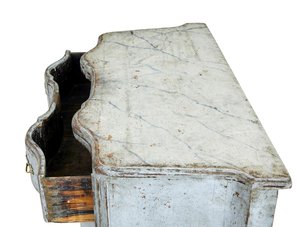 An early nineteenth-century Swedish Baroque Revival chest featuring three drawers with a distressed light blue painted finish and decorative brass handles. View III