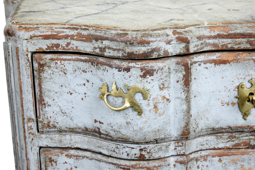 An early nineteenth-century Swedish Baroque Revival chest featuring three drawers with a distressed light blue painted finish and decorative brass handles. View IV