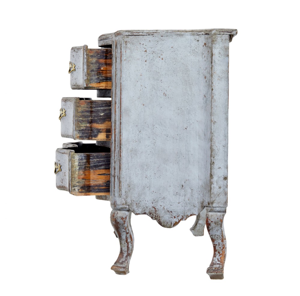An early nineteenth-century Swedish Baroque Revival chest featuring three drawers with a distressed light blue painted finish and decorative brass handles. View VII