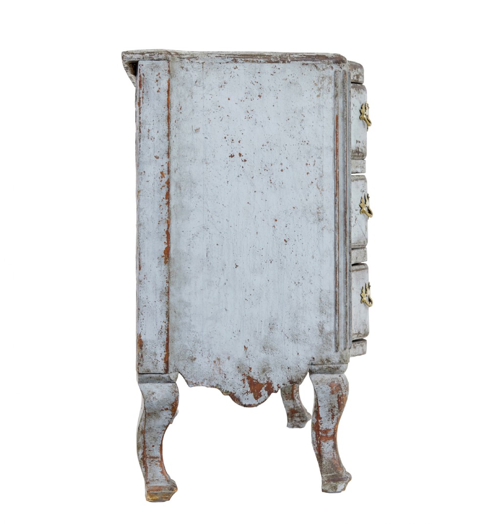 An early nineteenth-century Swedish Baroque Revival chest featuring three drawers with a distressed light blue painted finish and decorative brass handles. View IX