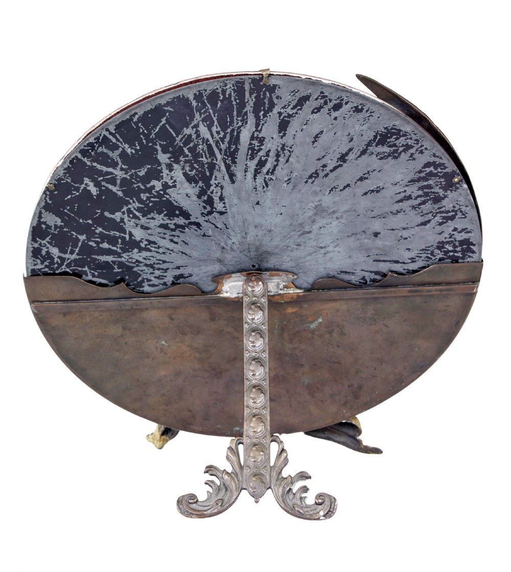 A circular table mirror featuring a cast bronze crescent man-in-the-moon frame and a brass cherub seated along the bottom edge. View IV