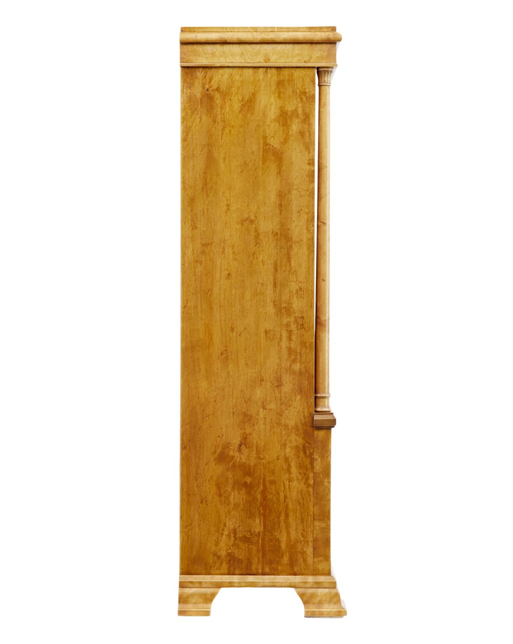 An early twentieth-century Empire Revival satin birch bookcase cabinet featuring open adjustable upper shelving and three lower panelled cupboard doors with a central carved drape motif. View VI