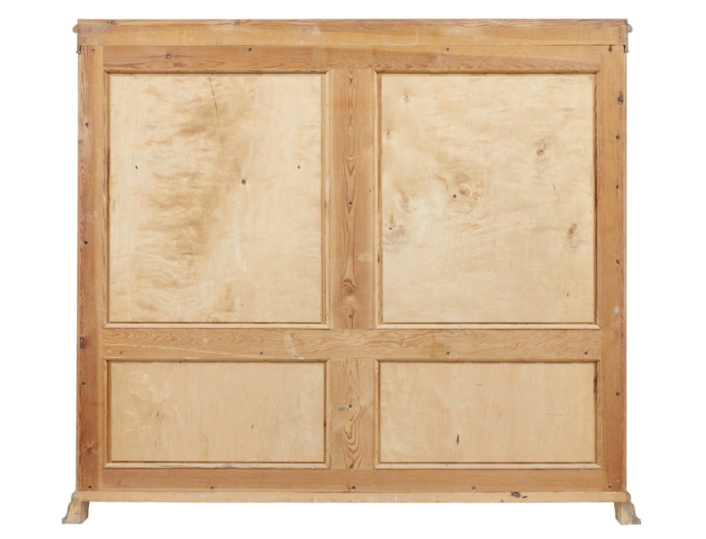 An early twentieth-century Empire Revival satin birch bookcase cabinet featuring open adjustable upper shelving and three lower panelled cupboard doors with a central carved drape motif. View VIII