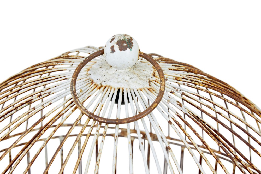 A large 19th-century domed wire bird cage with a distressed painted white finish showing areas of natural oxidisation and a top hanging loop. View VI
