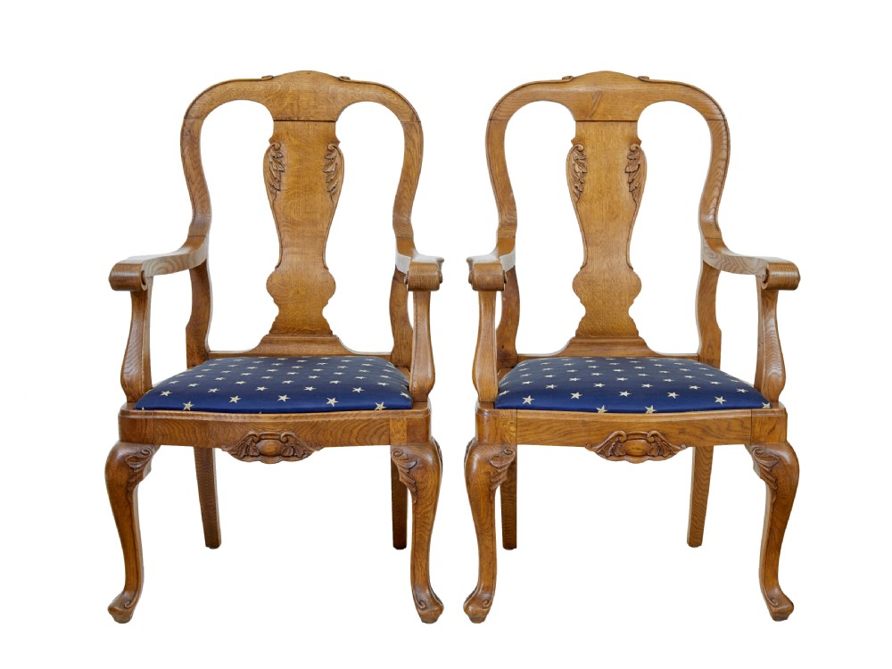 A pair of 19th-century carved oak open armchairs featuring vasiform splats, cabriole legs, carved seat aprons, and blue star-patterned upholstery. View II