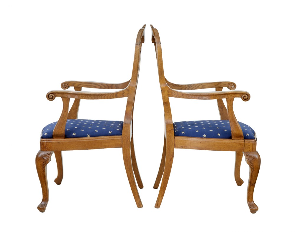 A pair of 19th-century carved oak open armchairs featuring vasiform splats, cabriole legs, carved seat aprons, and blue star-patterned upholstery. View III