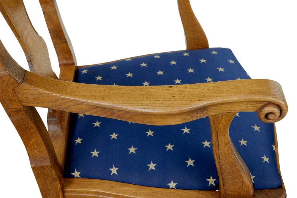 A pair of 19th-century carved oak open armchairs featuring vasiform splats, cabriole legs, carved seat aprons, and blue star-patterned upholstery. View VIII