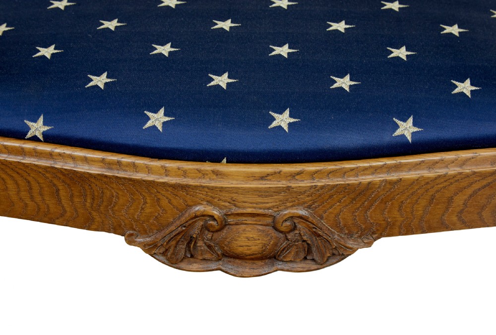 A pair of 19th-century carved oak open armchairs featuring vasiform splats, cabriole legs, carved seat aprons, and blue star-patterned upholstery. View IX