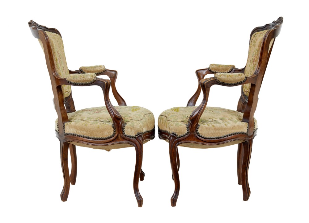 A pair of 19th-century French fauteuil armchairs with carved walnut frames and floral needlepoint upholstered seats and backs. View III