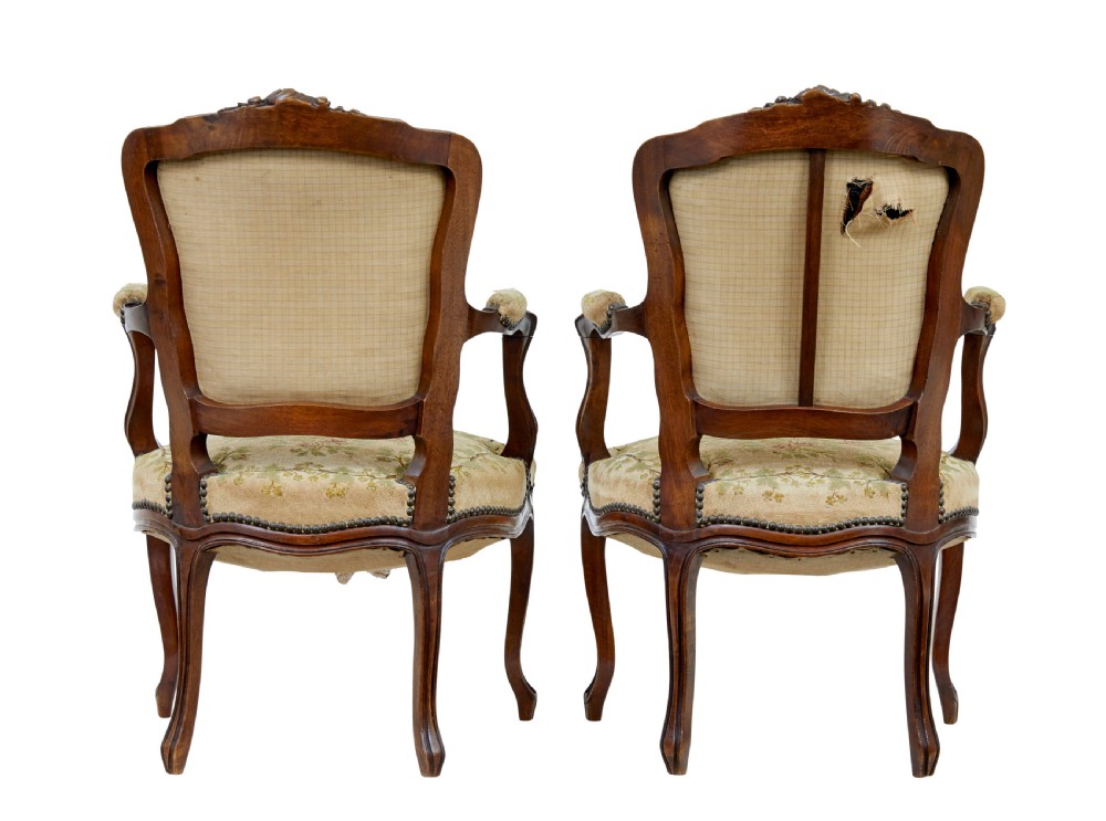 A pair of 19th-century French fauteuil armchairs with carved walnut frames and floral needlepoint upholstered seats and backs. View IV