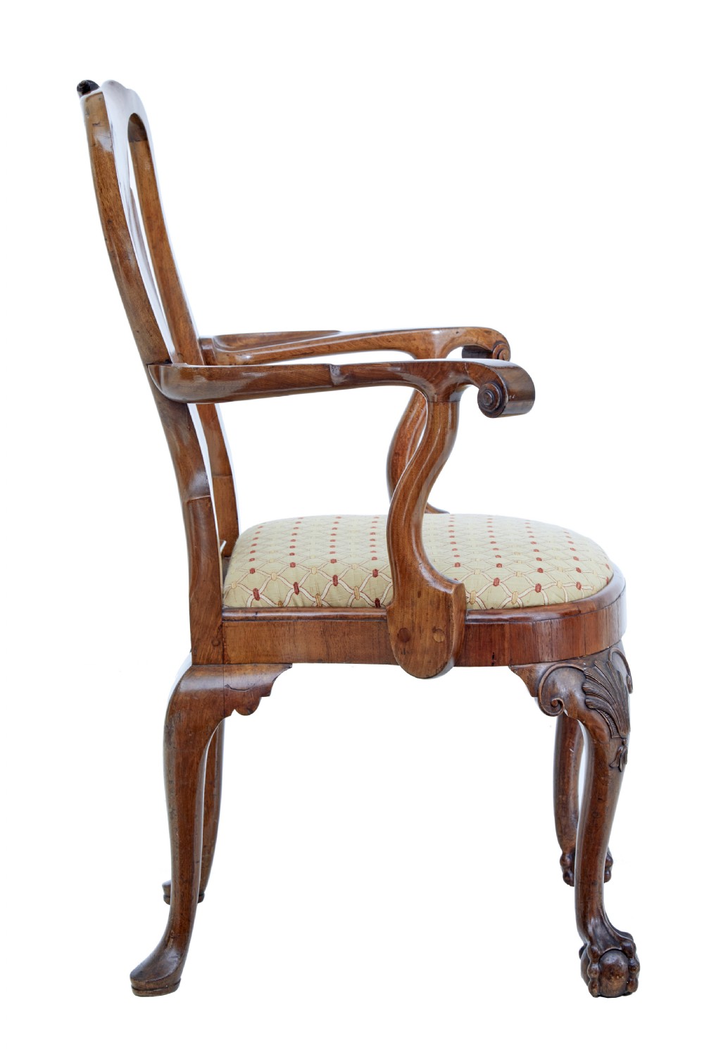 A set of carved walnut dining chairs featuring vasiform splat backs, upholstered drop-in seats, and cabriole legs ending in claw and ball feet. View V