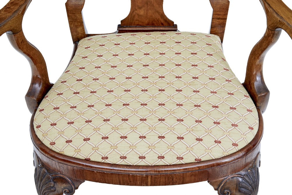 A set of carved walnut dining chairs featuring vasiform splat backs, upholstered drop-in seats, and cabriole legs ending in claw and ball feet. View VII