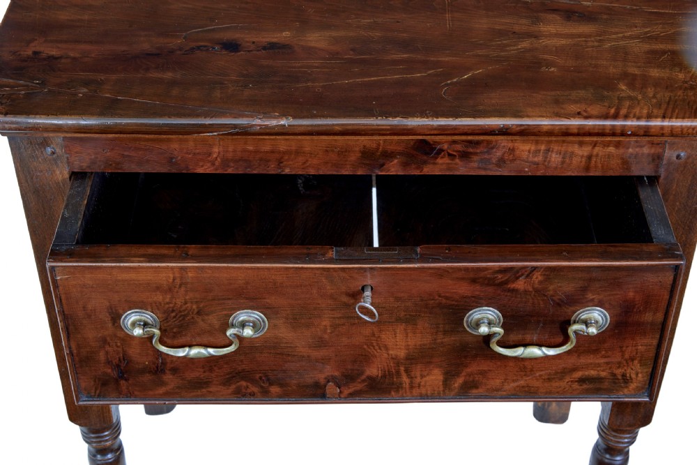An 18th-century yew wood lowboy table featuring a single drawer with brass handles, a scalloped apron, and turned legs. View IV