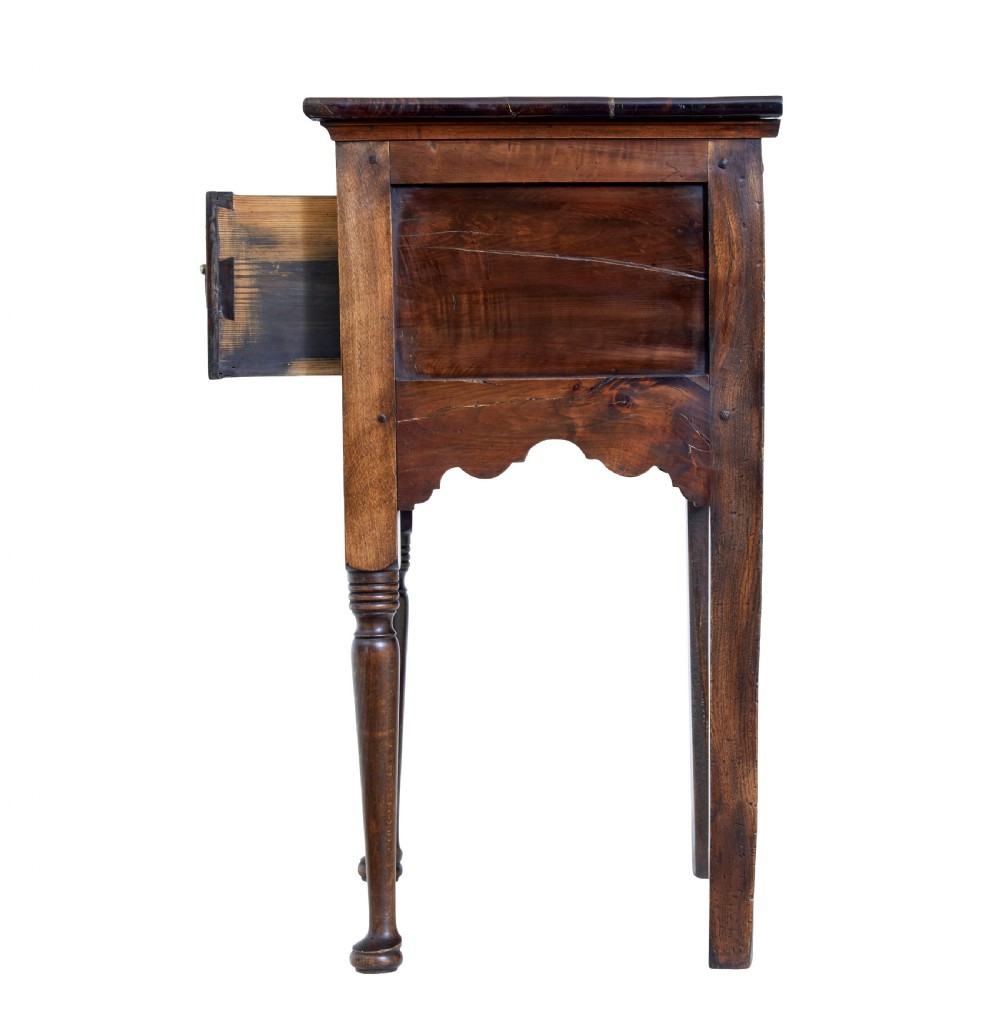 An 18th-century yew wood lowboy table featuring a single drawer with brass handles, a scalloped apron, and turned legs. View V