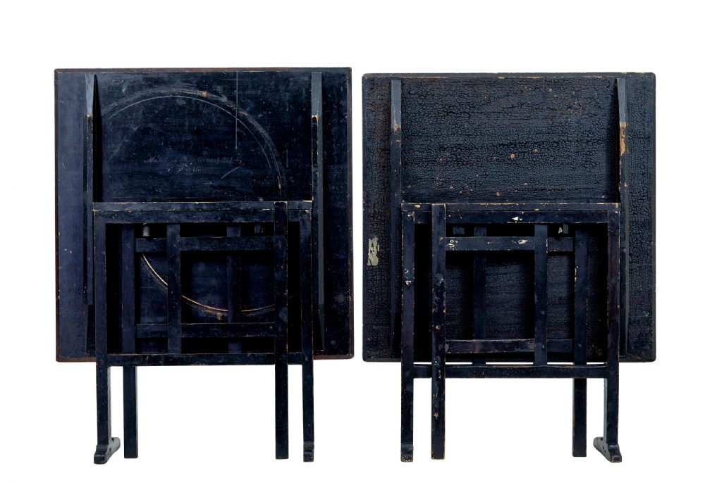 A pair of 19th-century Swedish folding tables featuring square tops with mottled brown ragwork painted surfaces supported on dark painted trestle bases. View V