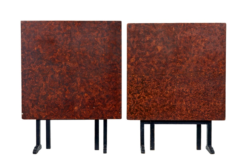 A pair of 19th-century Swedish folding tables featuring square tops with mottled brown ragwork painted surfaces supported on dark painted trestle bases. View VI