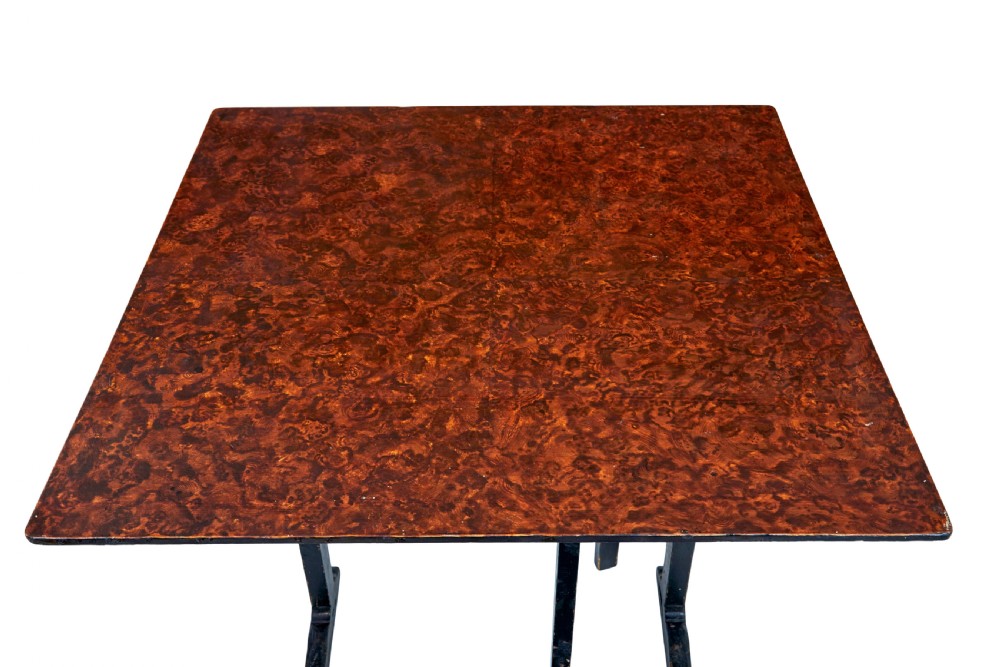 A pair of 19th-century Swedish folding tables featuring square tops with mottled brown ragwork painted surfaces supported on dark painted trestle bases. View VIII