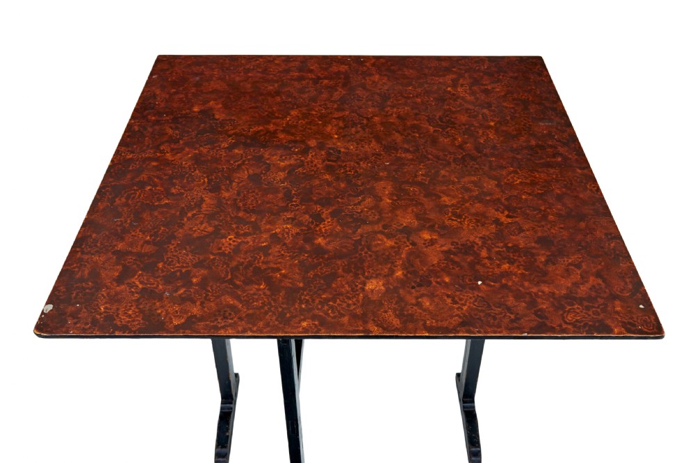 A pair of 19th-century Swedish folding tables featuring square tops with mottled brown ragwork painted surfaces supported on dark painted trestle bases. View IX
