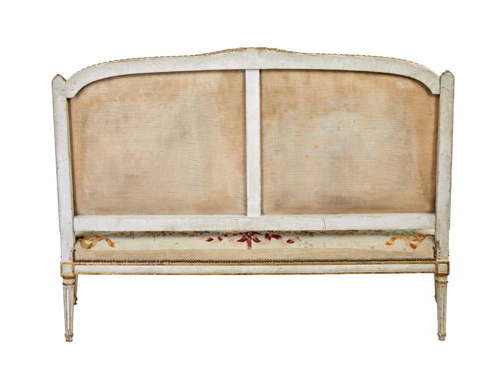 A five-piece French giltwood salon suite comprising four carved armchairs and a matching sofa, all upholstered in cream woven tapestry with floral and figurative medallions. View XIX