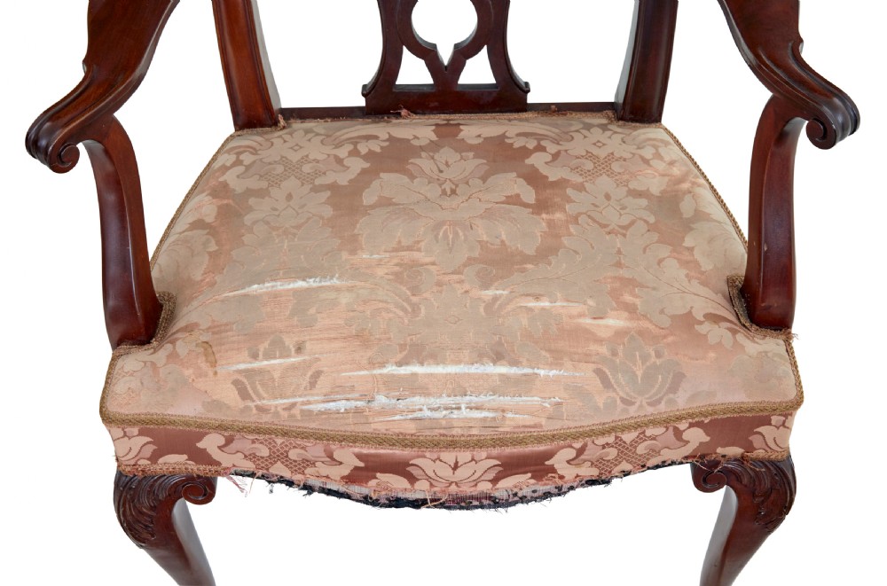 A pair of early 20th-century Chippendale Revival mahogany armchairs featuring carved pierced splat backs, serpentine top rails, curved arms, and cabriole legs. View III